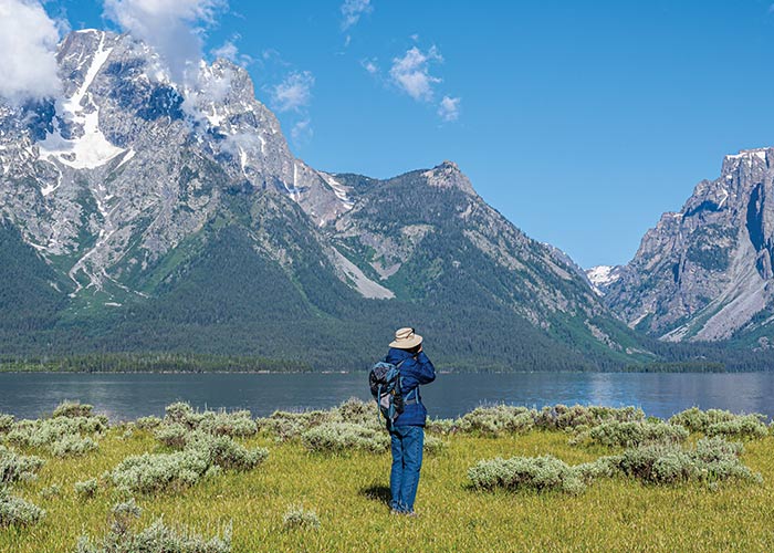 Alpine lake and rugged peaks in Grand Teton National Park visited during a guided shore excursion as part of a national parks cruise itinerary