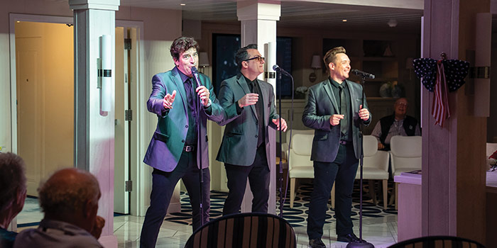 Live music performance by singers entertaining guests on board during an evening cruise event.