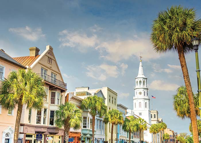 historic Charleston street scene called Rainbow Road with buildings of different colors and large white steeple