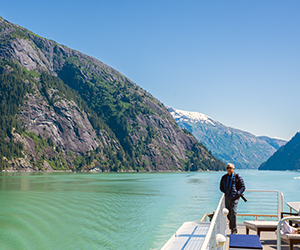 Scenic view of rocky cliffs and turquoise water from a small ship cruise through Endicott Arm.