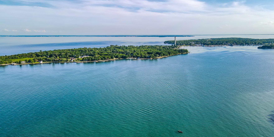 Aerial view of Middle Bass Island, on Lake Erie, surrounded by calm blue waters under a clear sky.