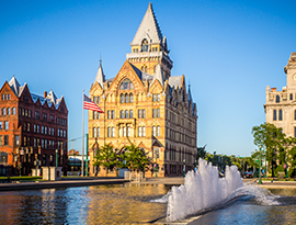 Historic 19th century building with pointed roof in Clinton Square, Syracuse, NY.