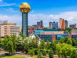 Skyline with the Sunsphere tower, modern buildings, and trees along the front during American Cruise Lines' stop in Knoxville, TN.