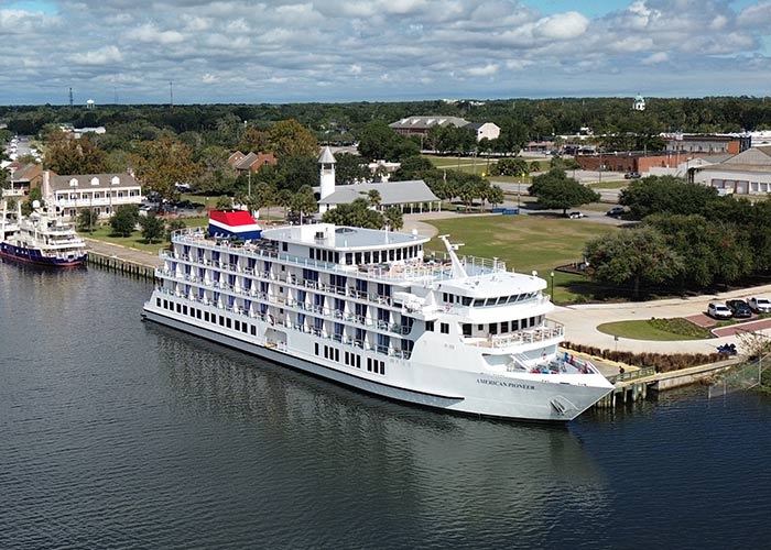 An aerial view of American Pioneer, an American Cruise Lines Patriot Class small cruise ship, docked along the Florida Gulf Coast.