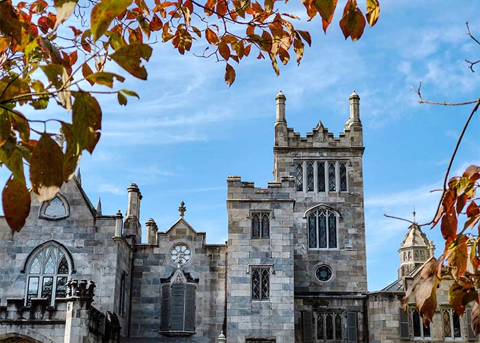 A close-up of Lyndhurst Mansion, a large, stone castle-like building with stained glass windows and several spires on the roof in Tarrytown.
