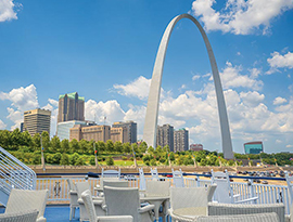 A view of the St. Louis Gateway Arch and several skyscrapers in the background from the sun deck of American Heritage, an American Cruise Lines Paddlewheeler.
